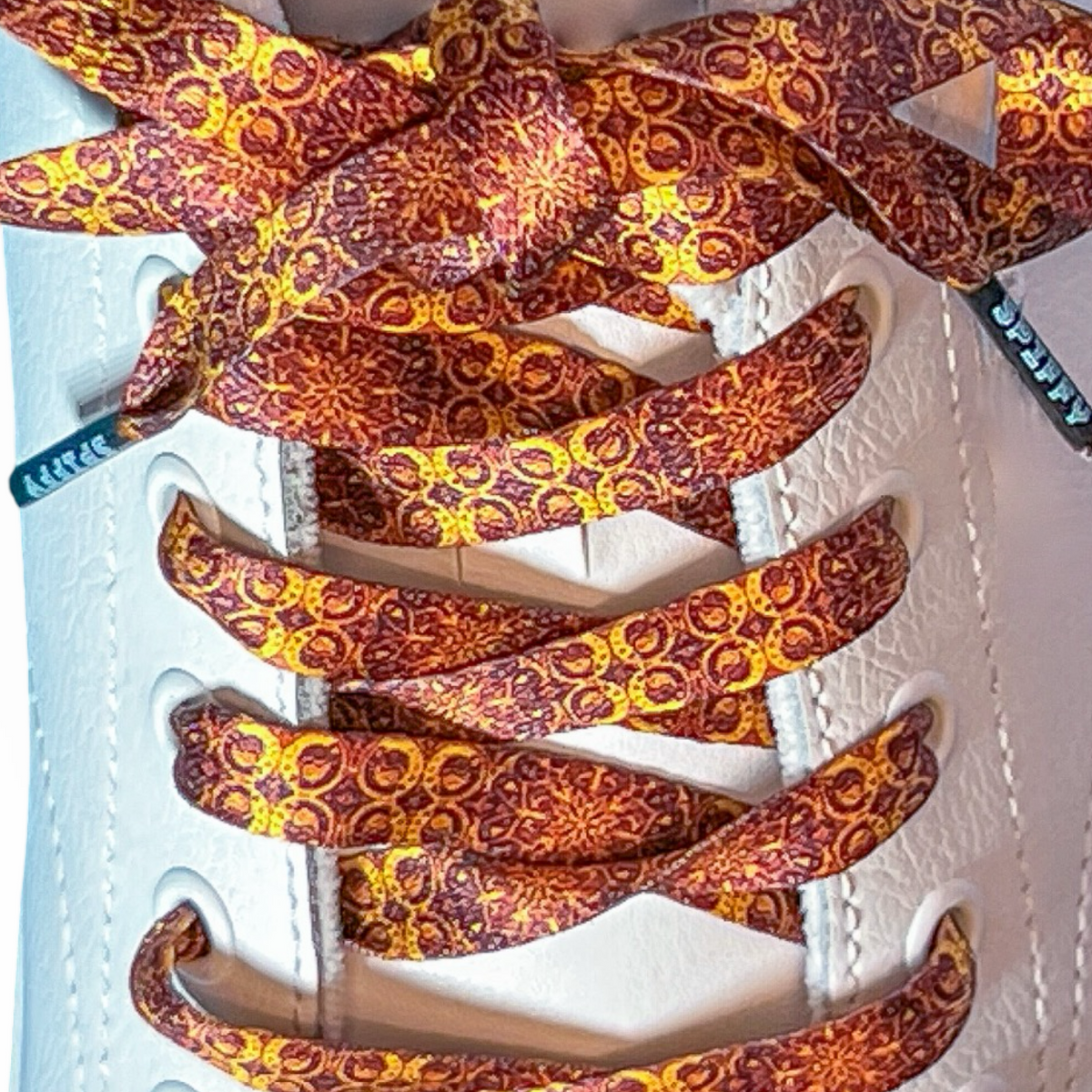 Close-up of patterned shoelaces on a white shoe