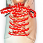 White sneaker with red heart-patterned shoelaces on a white background