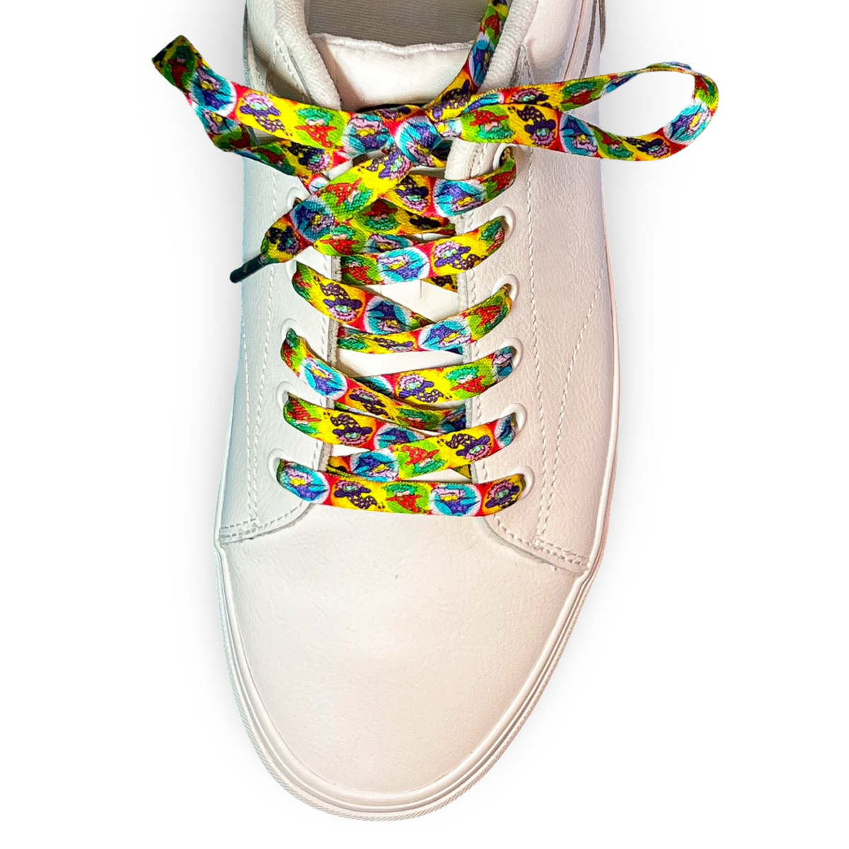 White sneaker with colorful tie-dye wizard laces on a white background