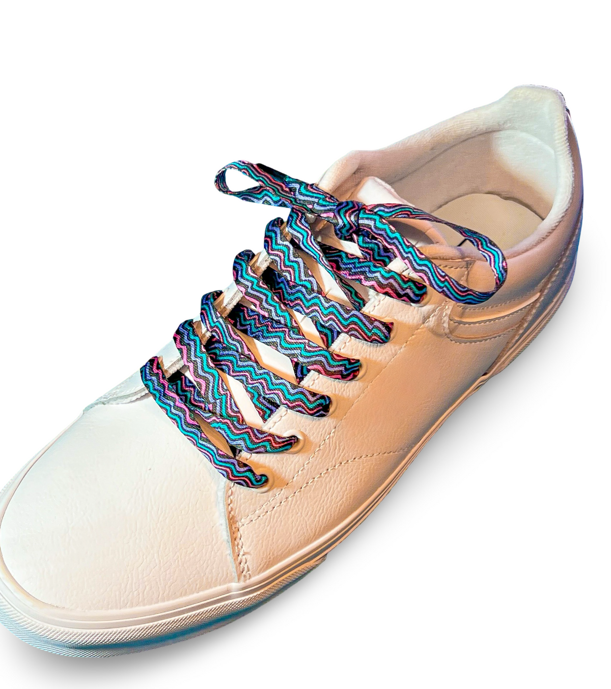Beige sneaker with colorful zigzag laces on a white background