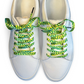 White sneakers with Green and yellow pickle patterned shoelaces on a white background