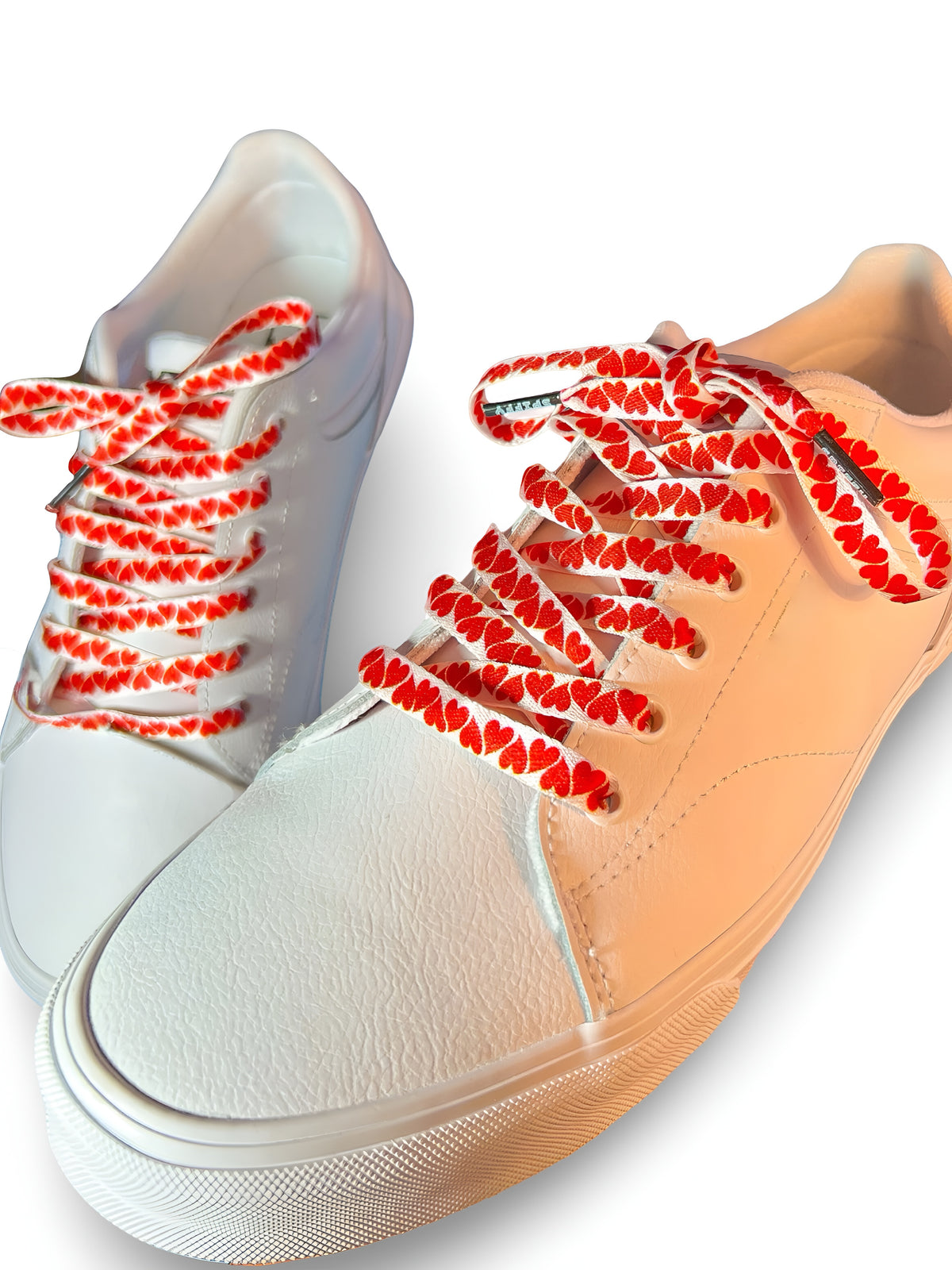 White and beige sneakers with colorful heart shoelaces on a white background