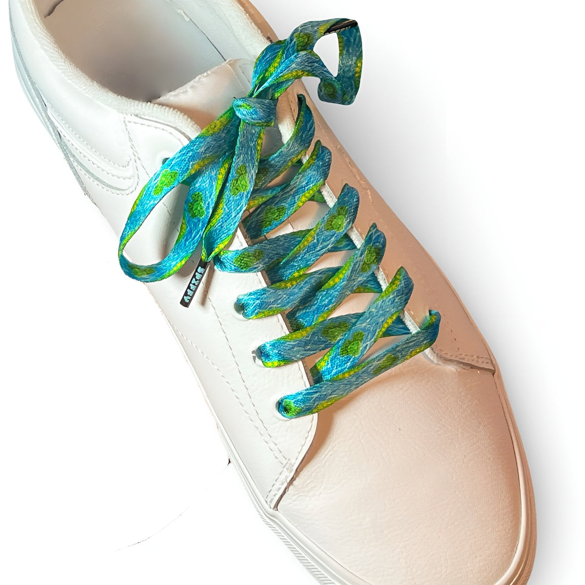 White sneaker with blue and green patterned shoelaces on a white background