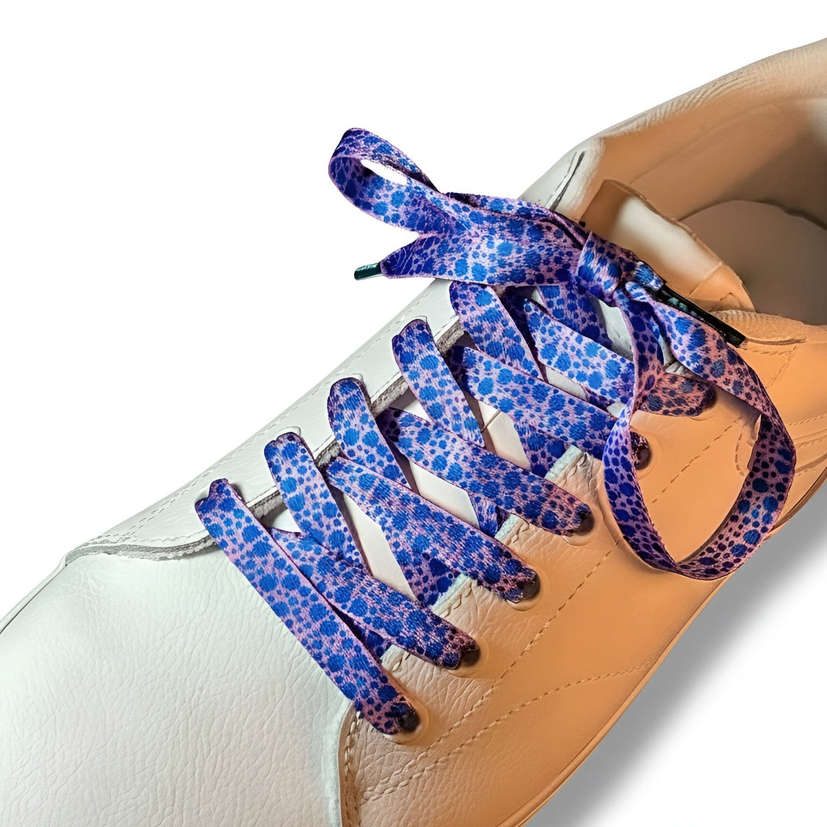 White sneaker with blueberry patterned laces on a white background