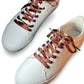 White sneakers with colorful laces on a white background