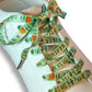 Shoe laces with Halloween-themed design on a white sneaker