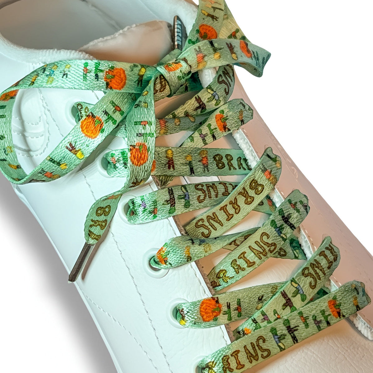 Shoe laces with Halloween-themed design on a white sneaker
