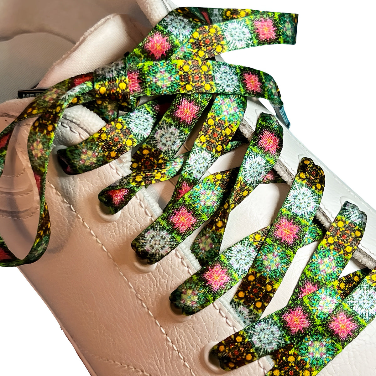 Close-up of floral-patterned shoelaces on a white sneaker