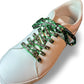 White sneaker with cow shoelaces on a white background
