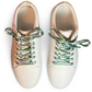 Pair of white sneakers with colorful butterfly themed laces on a white background