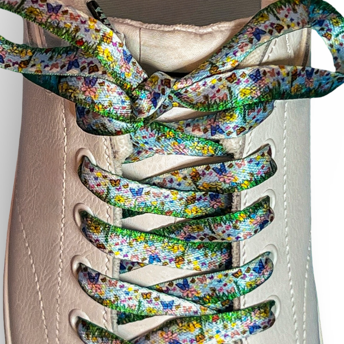 Colorful floral-patterned shoelaces on a white sneaker