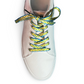 White sneaker with colorful palm tree shoelaces on a white background