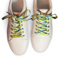 Pair of beige sneakers with colorful palm tree shoelaces on a white background