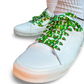 White sneakers with colorful football themed shoelaces on a white background