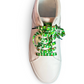 White sneaker with colorful football themed shoelaces on a white background
