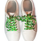 White sneakers with colorful football themed shoelaces on a white background