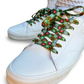 White sneakers with colorful floral-patterned laces on a white background