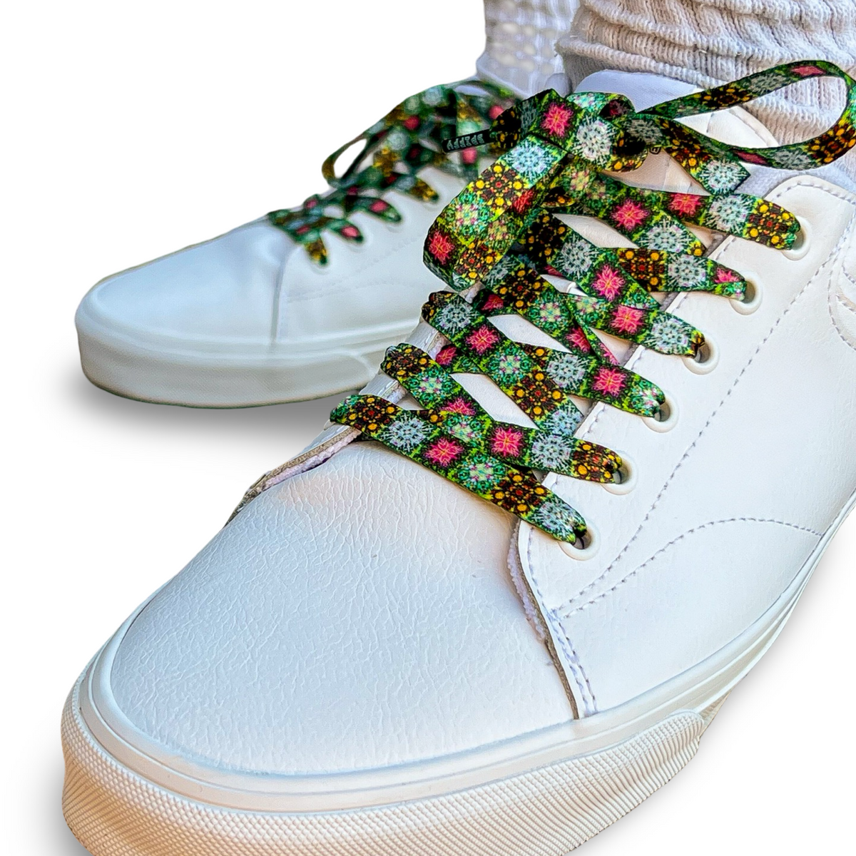 White sneakers with colorful floral-patterned laces on a white background