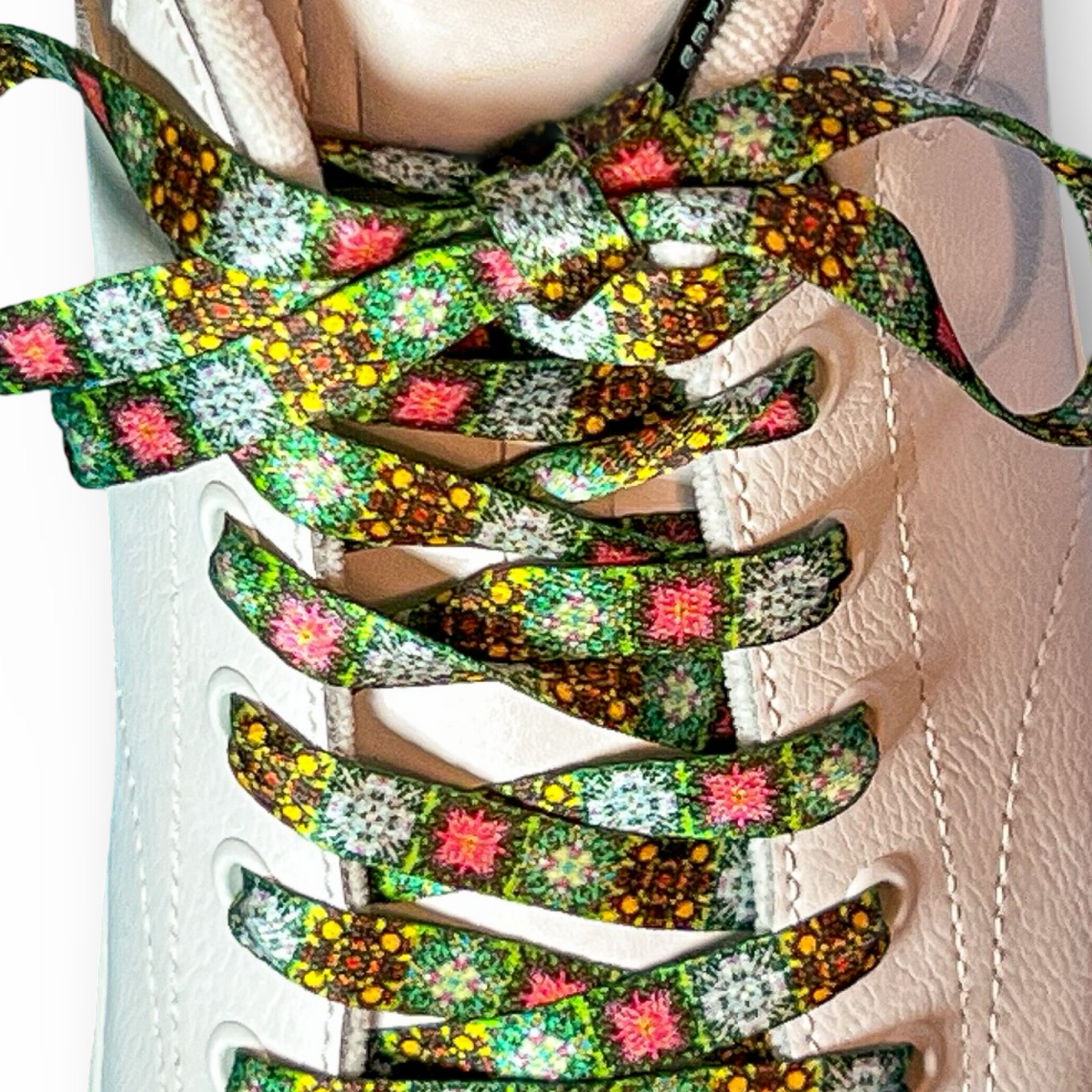 Colorful floral-patterned shoelaces on a white sneaker