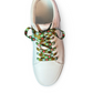 White sneaker with colorful printed laces on a white background