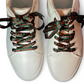 White sneakers with rose shoelaces  on a white background