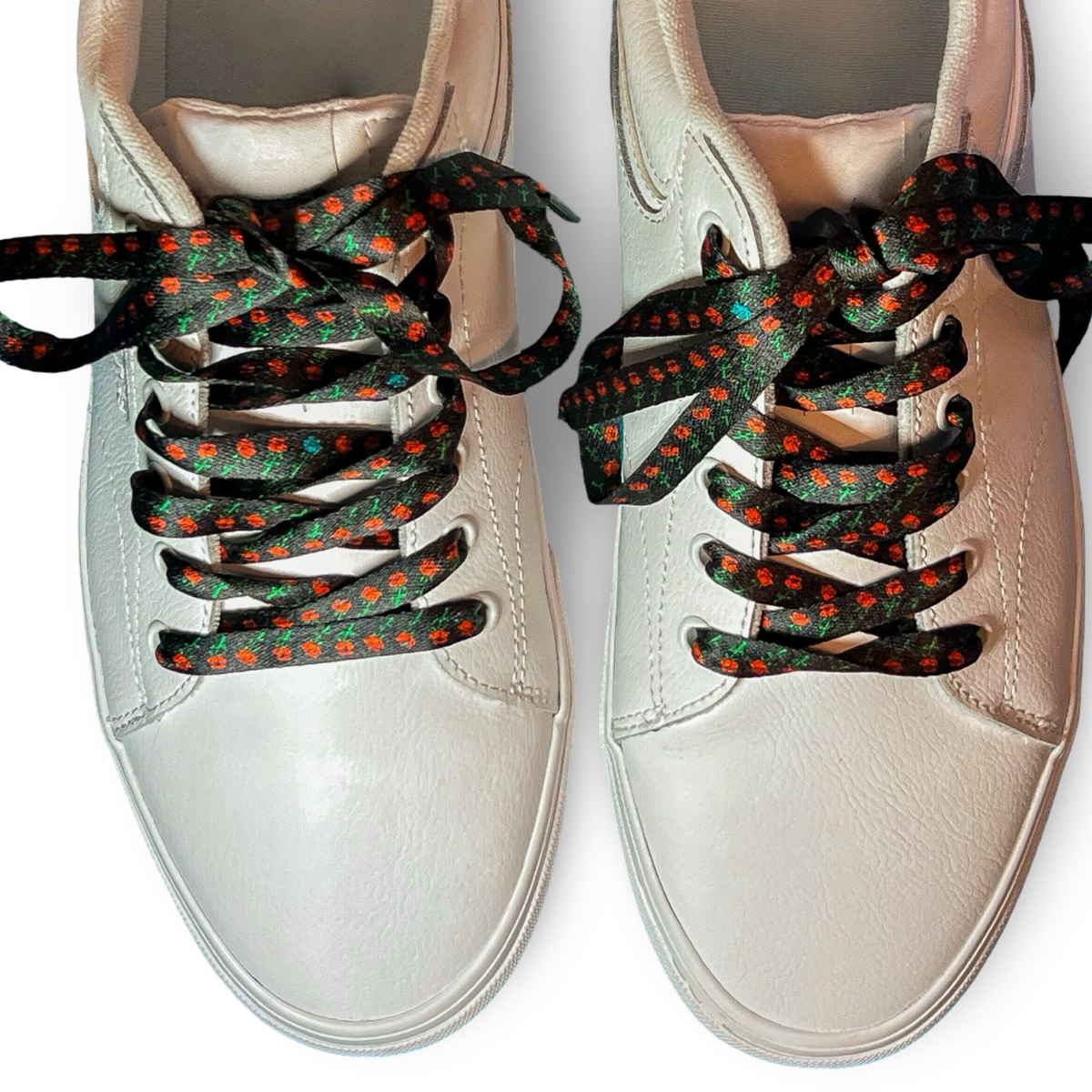 White sneakers with rose shoelaces  on a white background