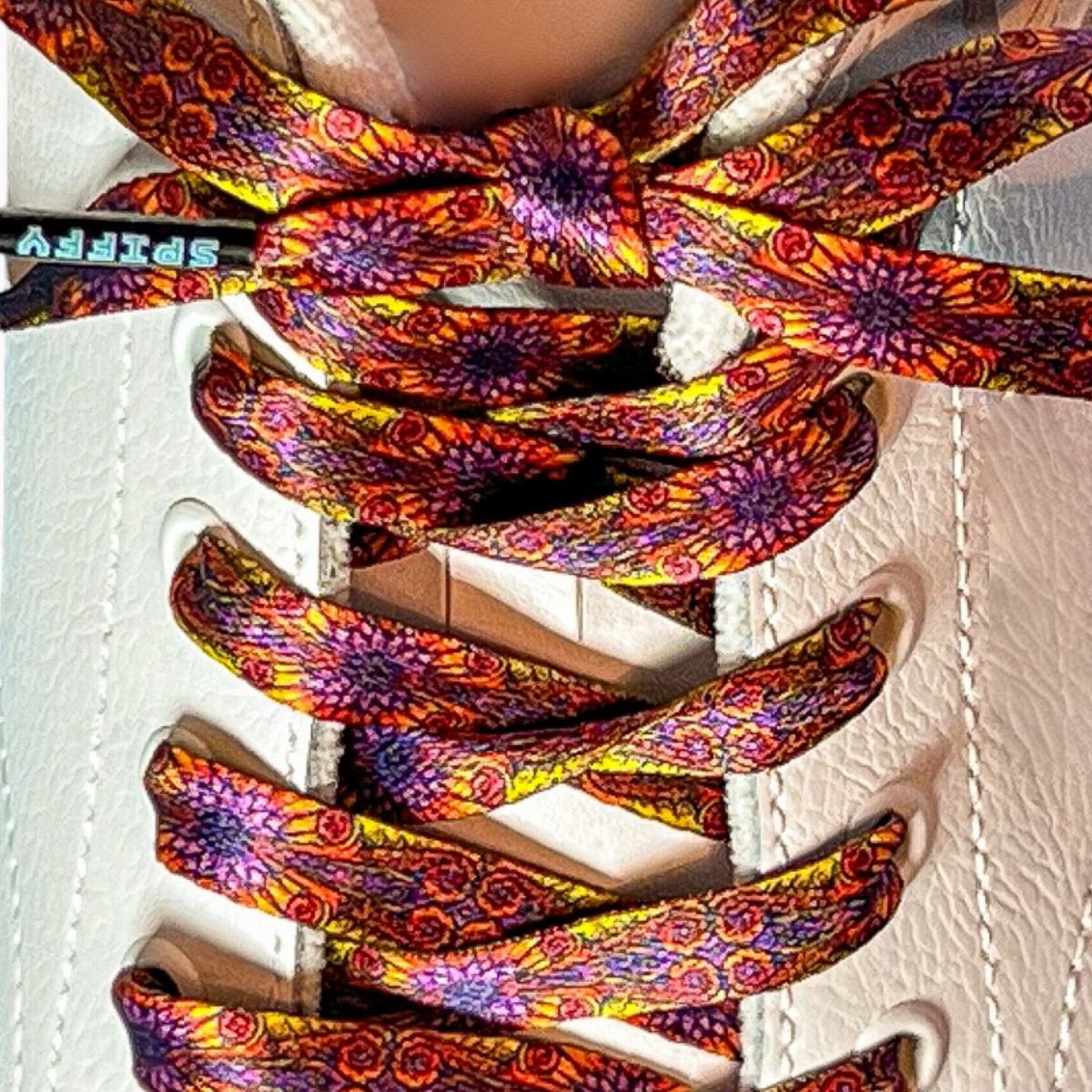 Colorful patterned shoelaces on a white sneaker