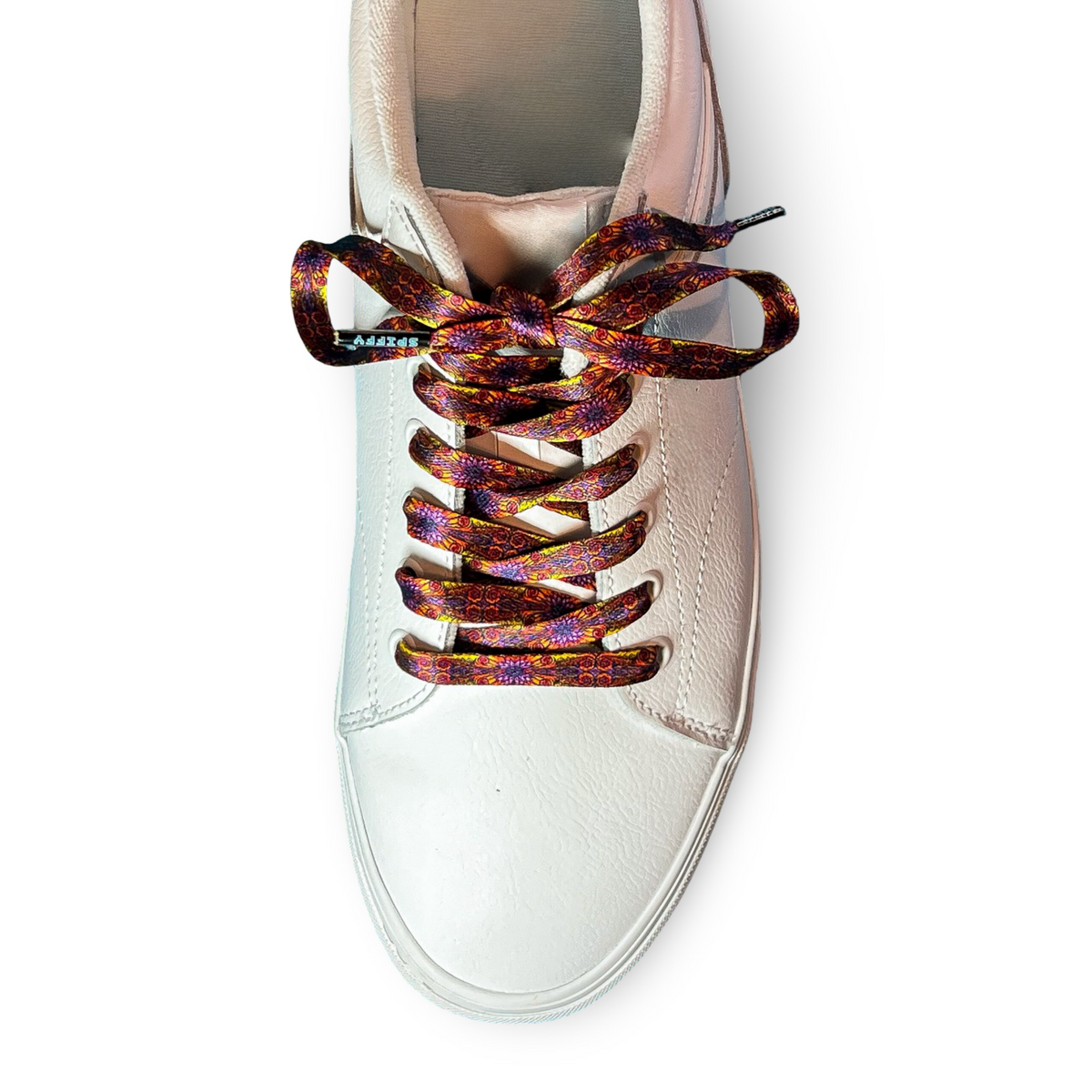 White sneaker with colorful shoelaces on a white background