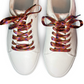 White sneakers with colorful shoelaces on a white background