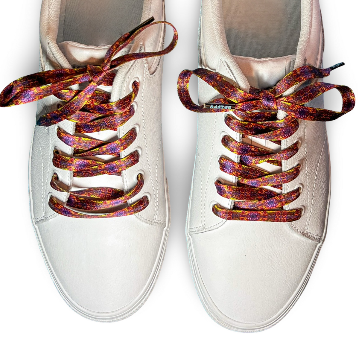 White sneakers with colorful shoelaces on a white background