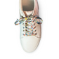 Rose gold sneaker with colorful mushroom shoelaces on a white background