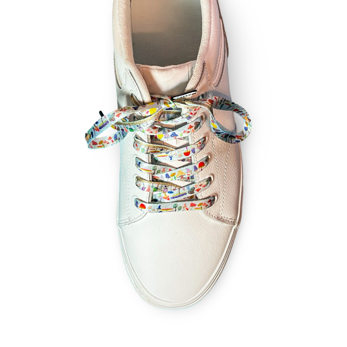 Rose gold sneaker with colorful mushroom shoelaces on a white background