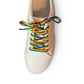 Beige sneaker with rainbow laces on a white background