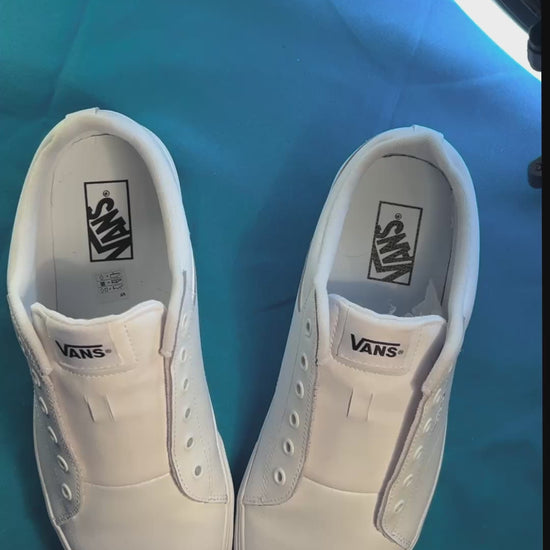 Palm tree patterned shoelaces being laced up on a fresh pair of white sneakers