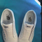 Palm tree patterned shoelaces being laced up on a fresh pair of white sneakers