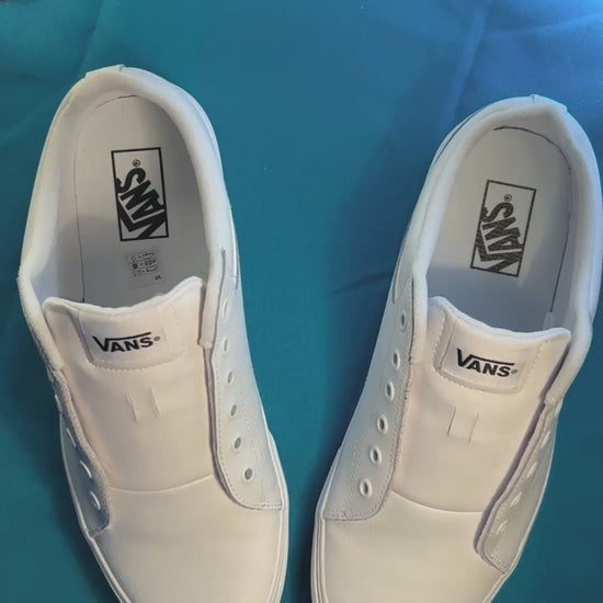 Colorful football themed shoelaces being laces up on a fresh pair of white sneakers