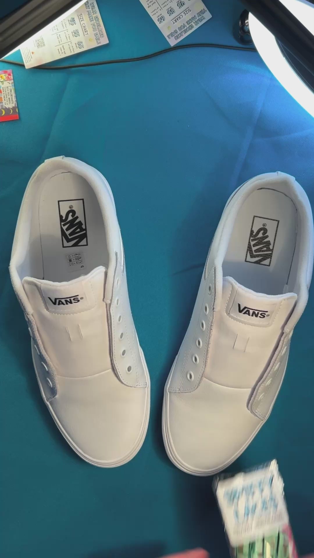 Colorful football themed shoelaces being laces up on a fresh pair of white sneakers