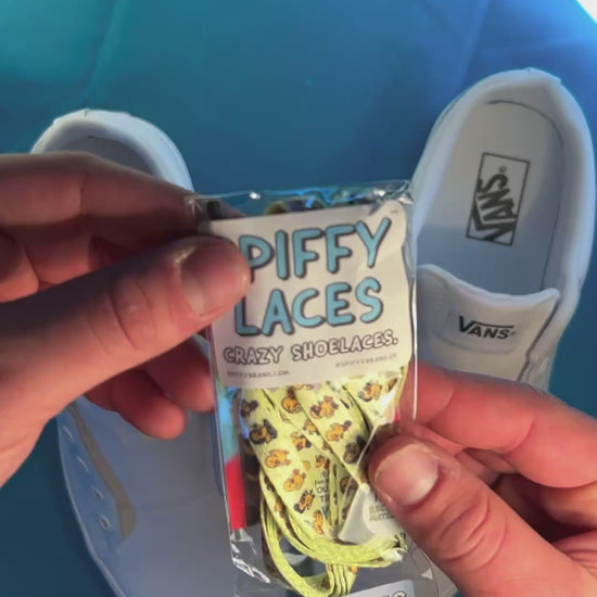 Yellow duck themed shoelaces being laced up on a fresh pair of white sneakers
