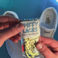Yellow duck themed shoelaces being laced up on a fresh pair of white sneakers
