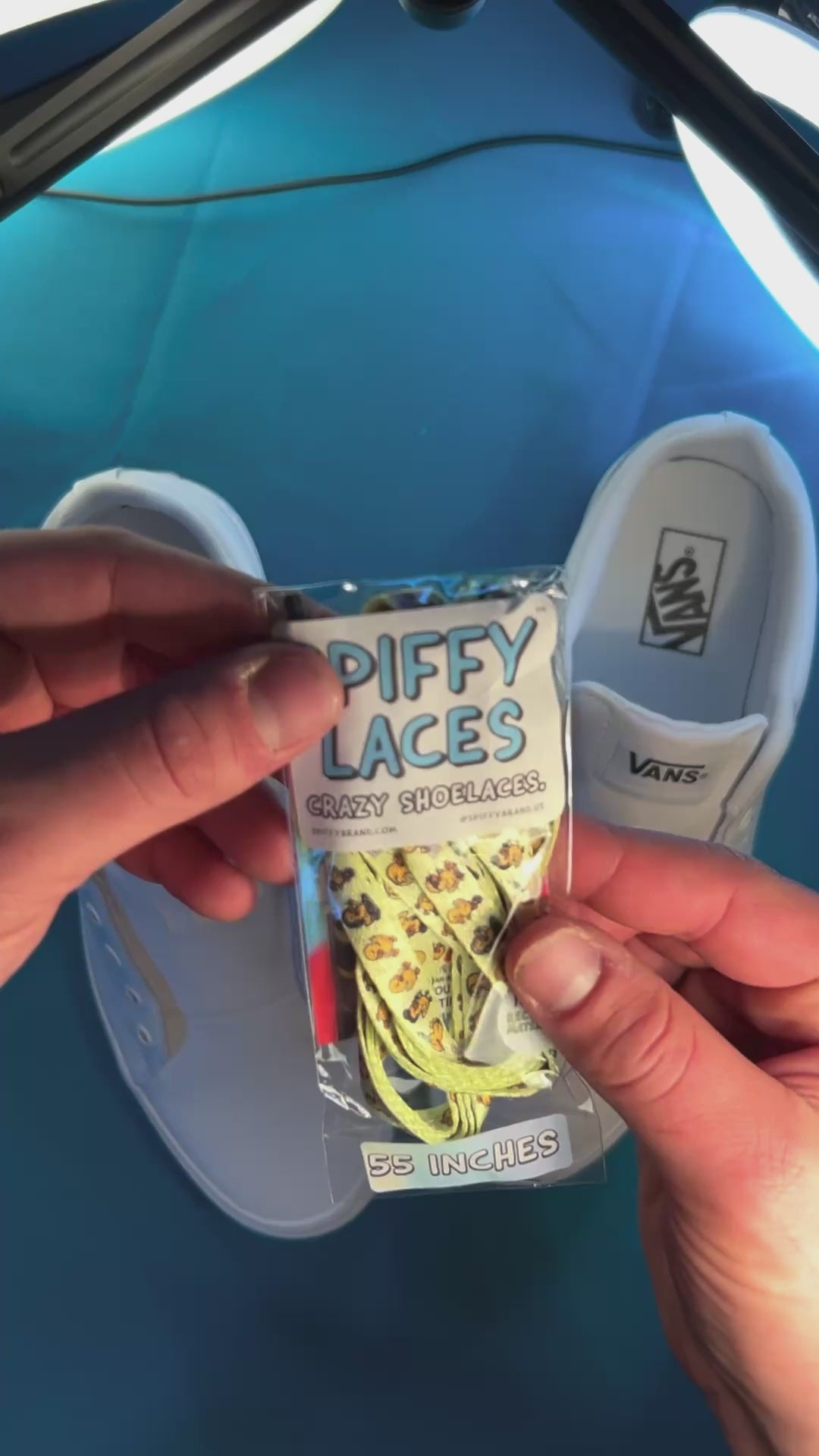 Yellow duck themed shoelaces being laced up on a fresh pair of white sneakers