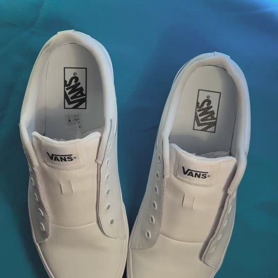 Diamond patterned shoelaces getting laced up on a fresh pair of white sneakers