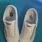 Diamond patterned shoelaces getting laced up on a fresh pair of white sneakers