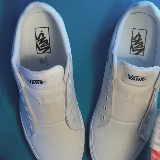 colorful heart shoelaces being laced up onto a fresh pair of white sneakers
