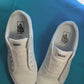 Blueberry themed shoelaces being laced up on a fresh pair of white sneakers