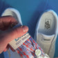 Colorful and fun lobster shoelaces being laced up on a fresh pair of white sneakers