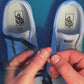 Colorful retro shoelaces being laced on on a fresh pair of white sneakers