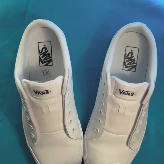 Colorful butterfly themed laces being laced up on a fresh pair of white sneakers.