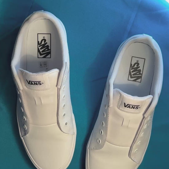 dark colored cow shoelaces being laced up on a fresh pair of white sneakers
