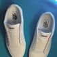 dark colored cow shoelaces being laced up on a fresh pair of white sneakers
