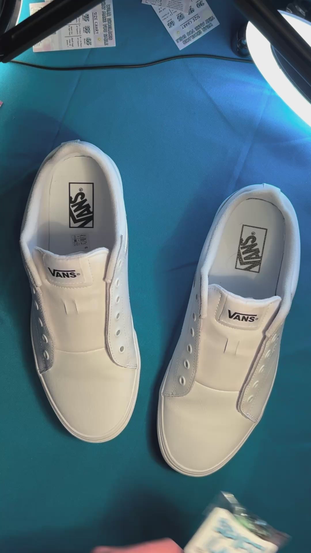 dark colored cow shoelaces being laced up on a fresh pair of white sneakers